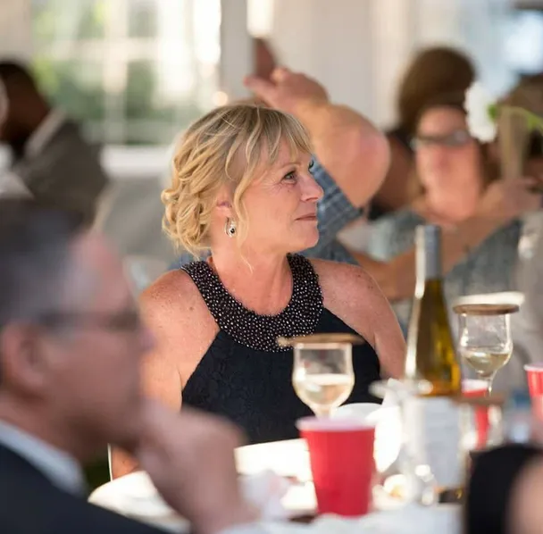 A smiling woman at a wedding reception